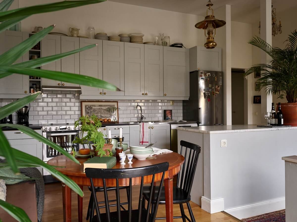 Floor-to-Ceiling Bookcases in a 1950s Swedish Home 10 light gray kitchen and round dining table
