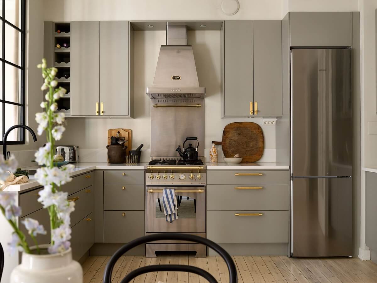 A Social Scandinavian Apartment with a Light Blue Living Room 4 light gray kitchen with brass fittings