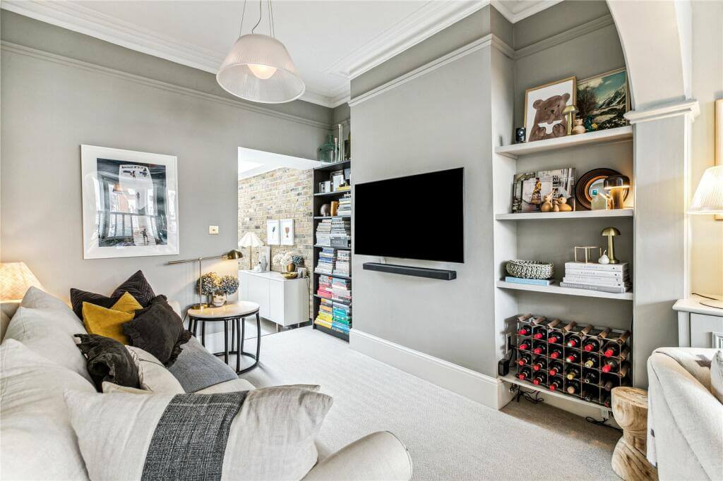An Extended Victorian House Decorated in Gray Tones 2 light gray walls in television room