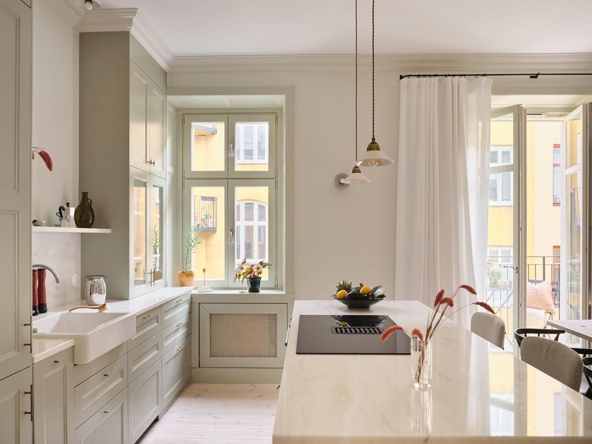 A Light Filled Duplex Apartment in Sweden 5 light kitchen with island and butler sink