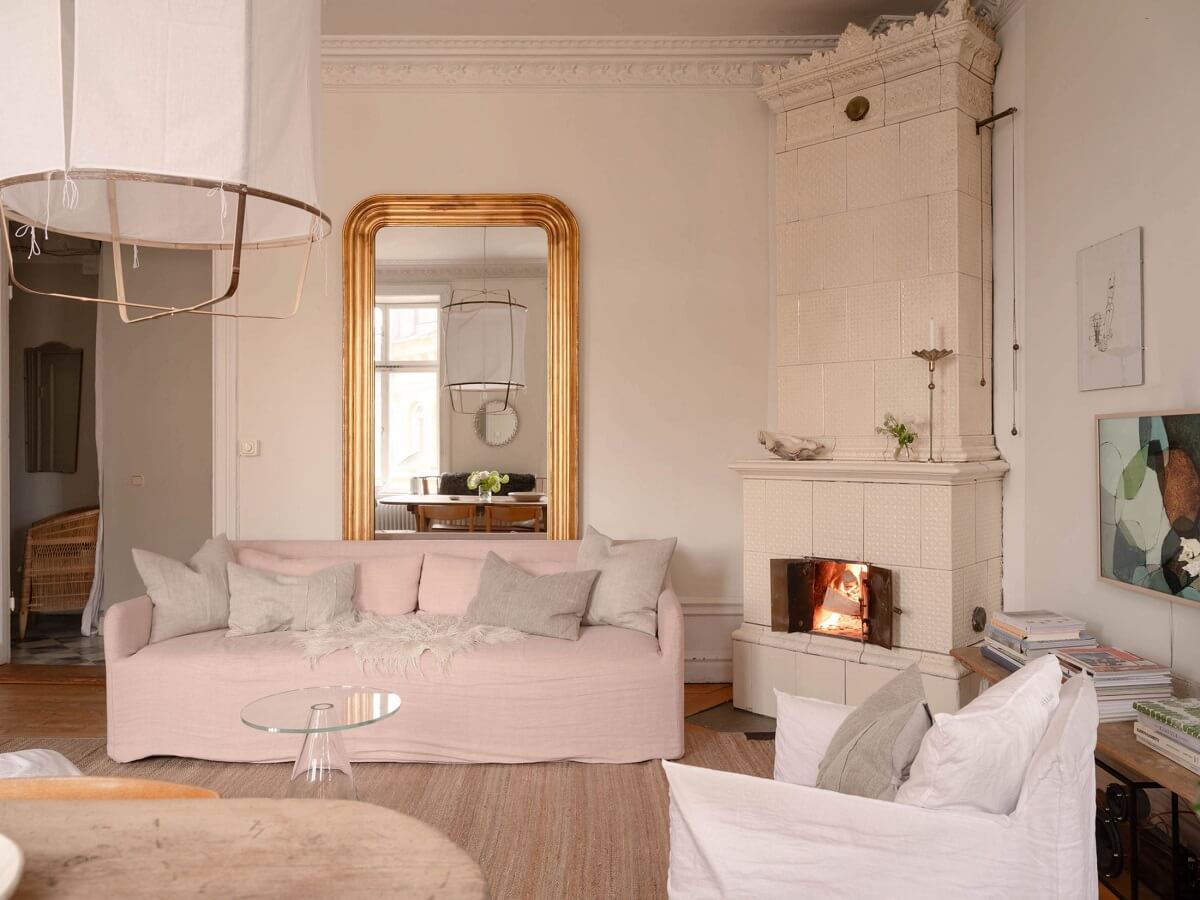Elsa Billgren's Serene Stockholm Apartment is For Sale 2 light living room with gilded mirror and fireplace