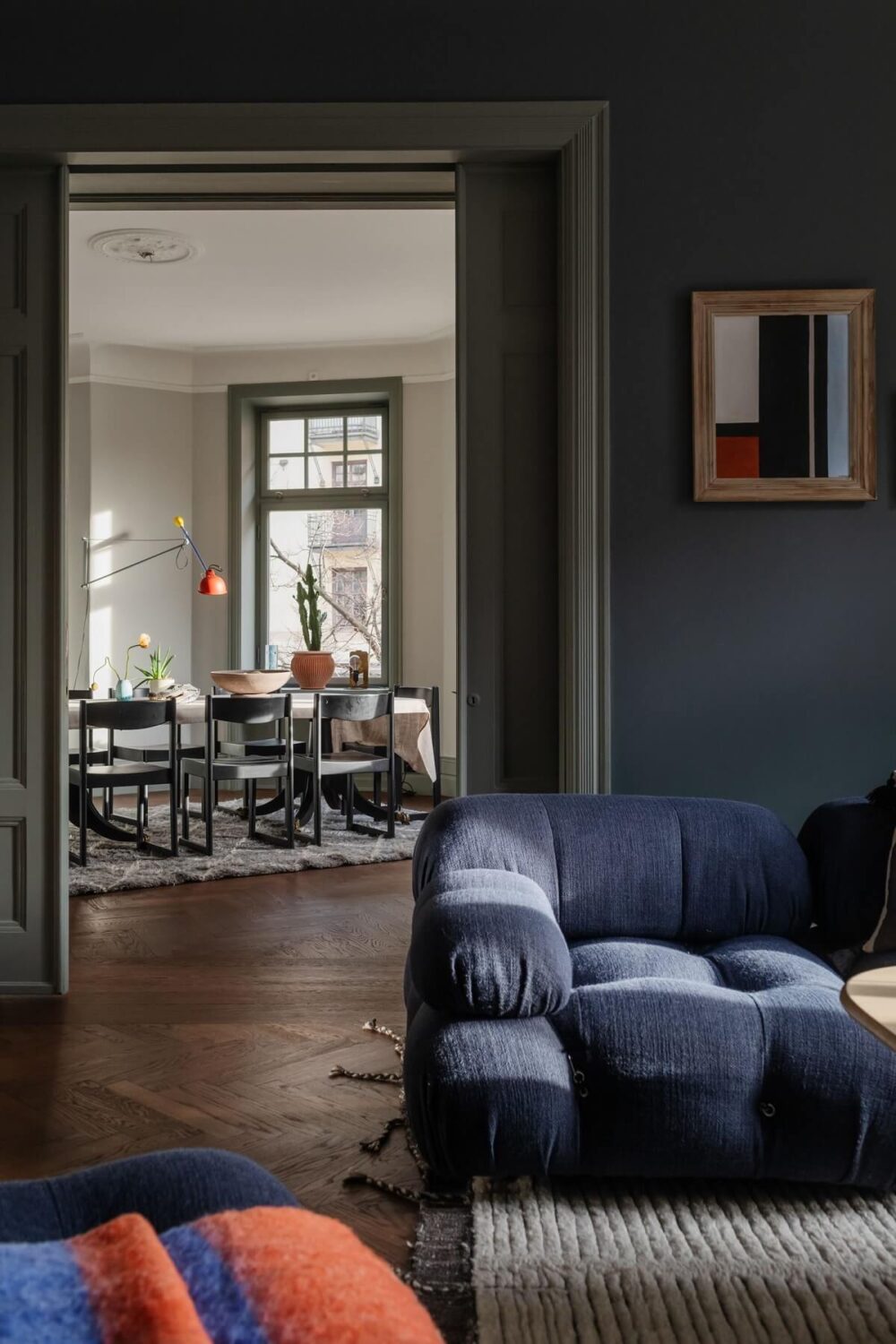 Moody Rooms in a Grand Stockholm Apartment 8 living room blue walls view into dining room
