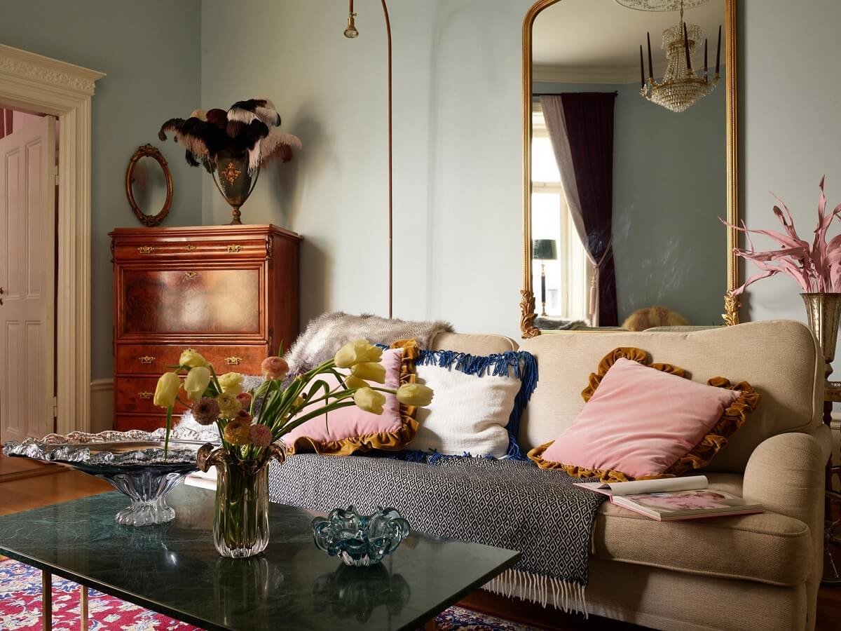 A Classic & Cozy Apartment Painted in Pastel Pink and Blue 2 living-room-pastel-pink-walls-gilded-mirror-above-sofa-nordroom