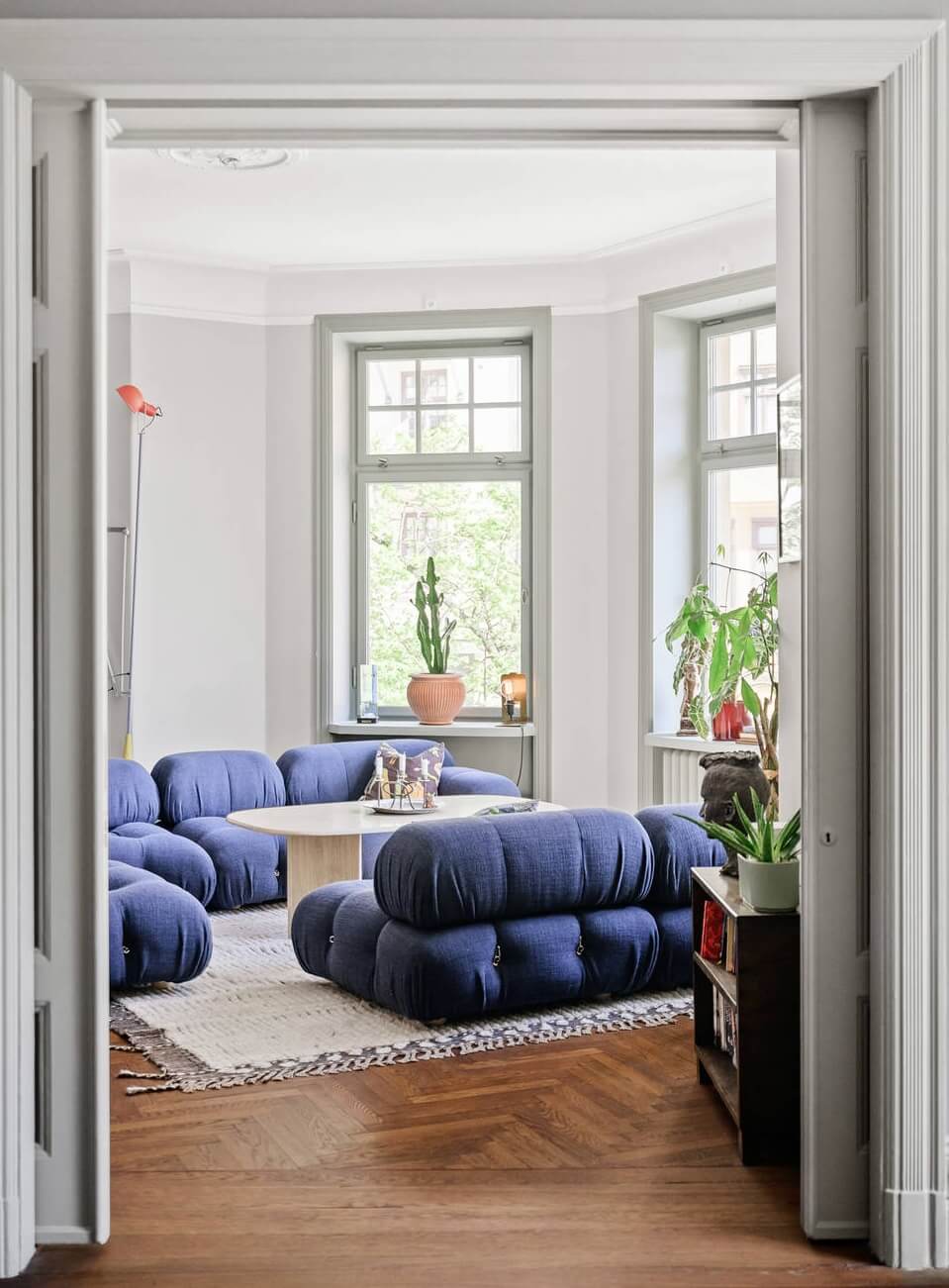 Moody Rooms in a Grand Stockholm Apartment 25 living room with bay window and blue sofa