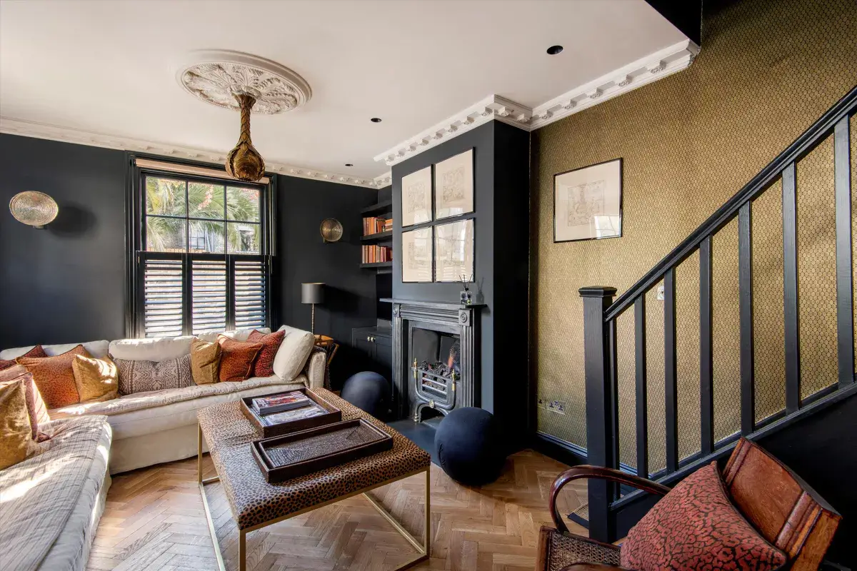 A Stylish Renovated House in Notting Hill 3 living room with dark gray wall and gold accent wall