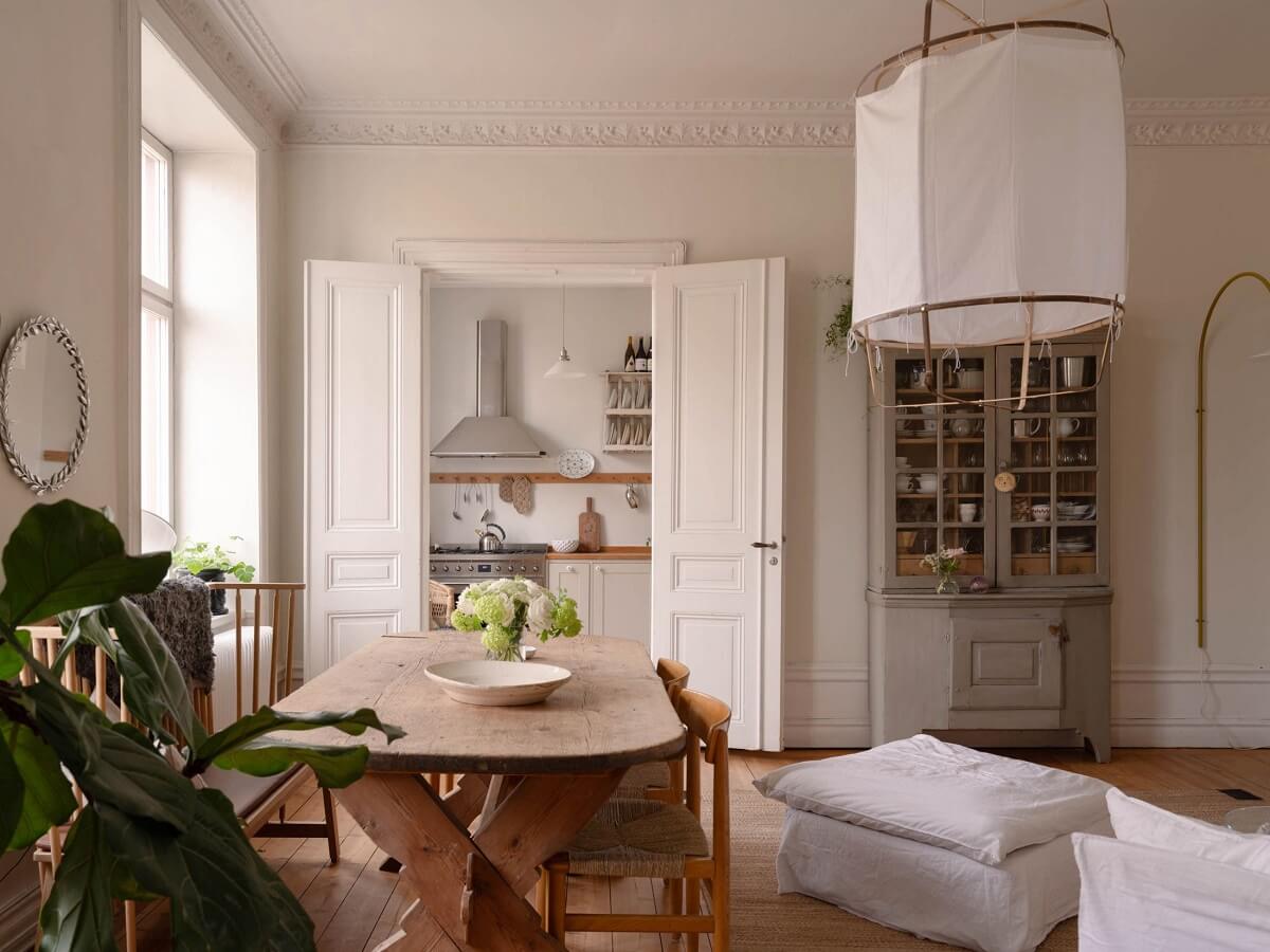 Elsa Billgren's Serene Stockholm Apartment is For Sale 8 living room with double wooden doors to the kitchen