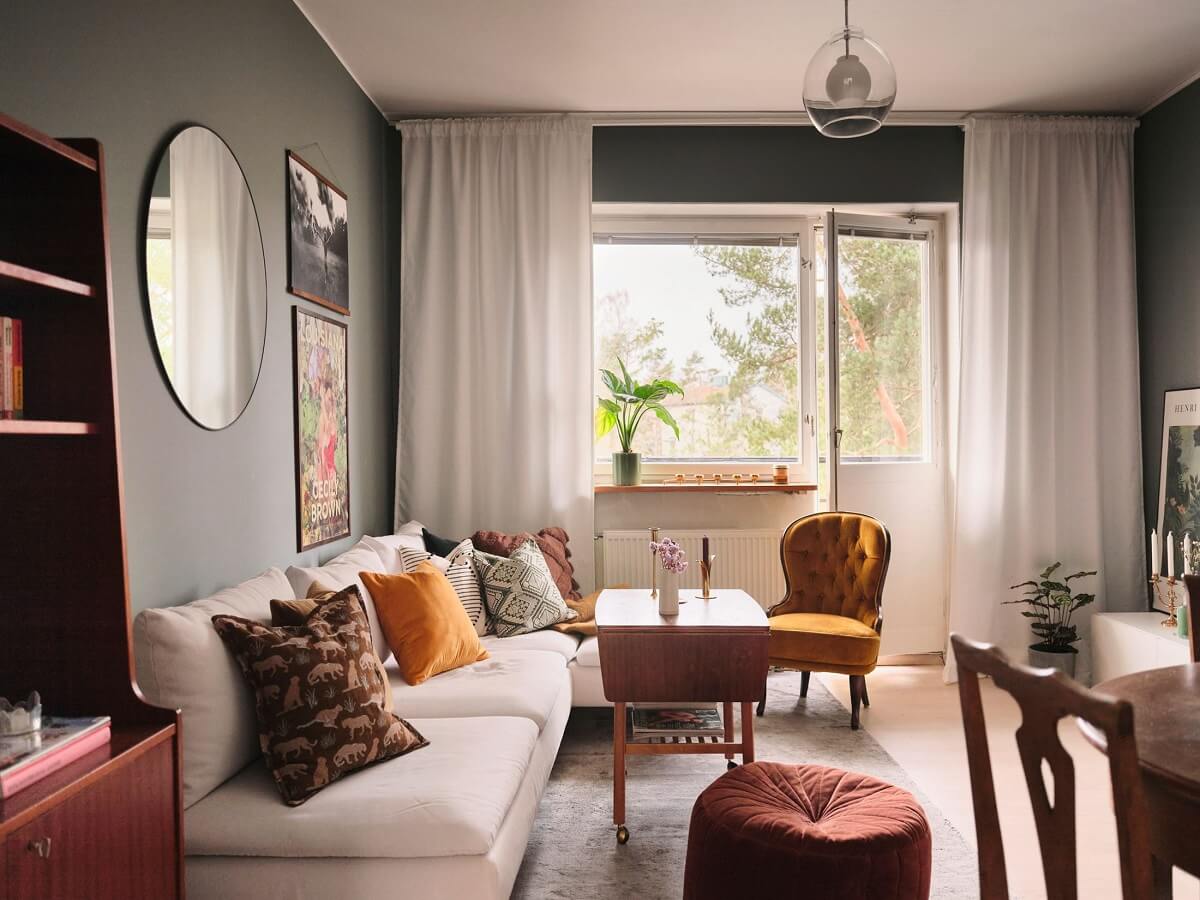 A Small Midcentury Apartment in Stockholm 3 living room with gray walls and midcentury design