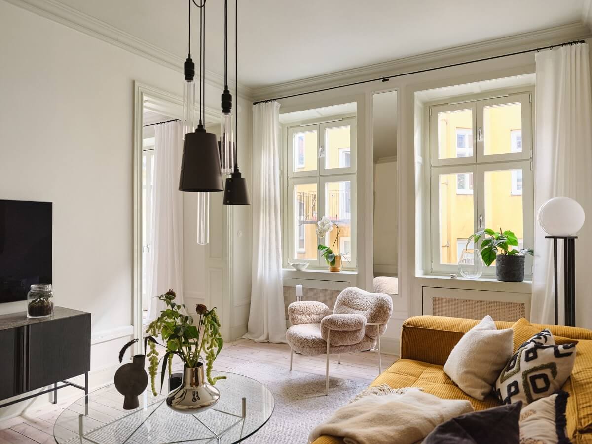 A Light Filled Duplex Apartment in Sweden 13 living room with ochre yellow sofa