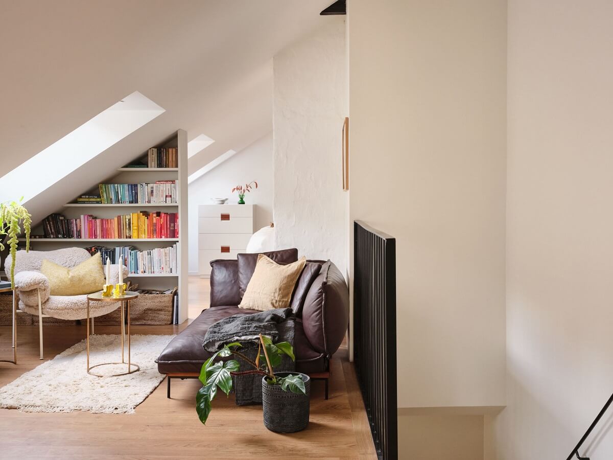 A Light Filled Duplex Apartment in Sweden 16 living room with slanted ceiling