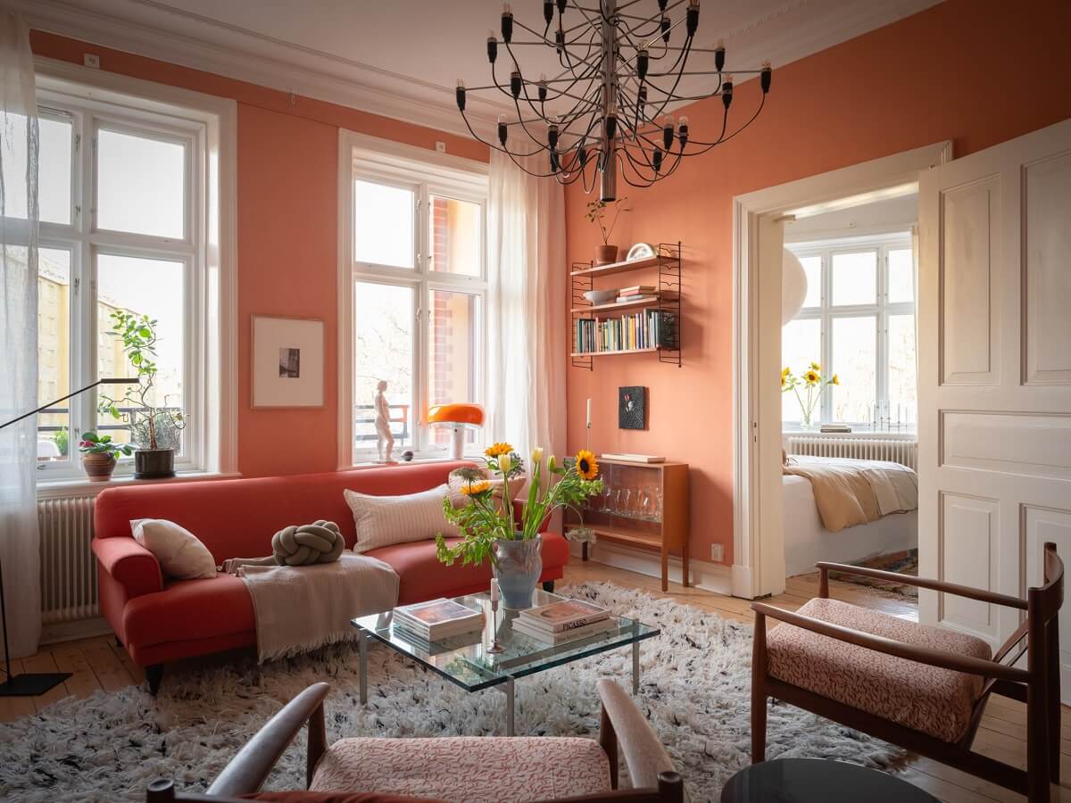 A Scandinavian Apartment with a Warm Living Room and Rounded Walls 2 living room with terracotta shade color on walls