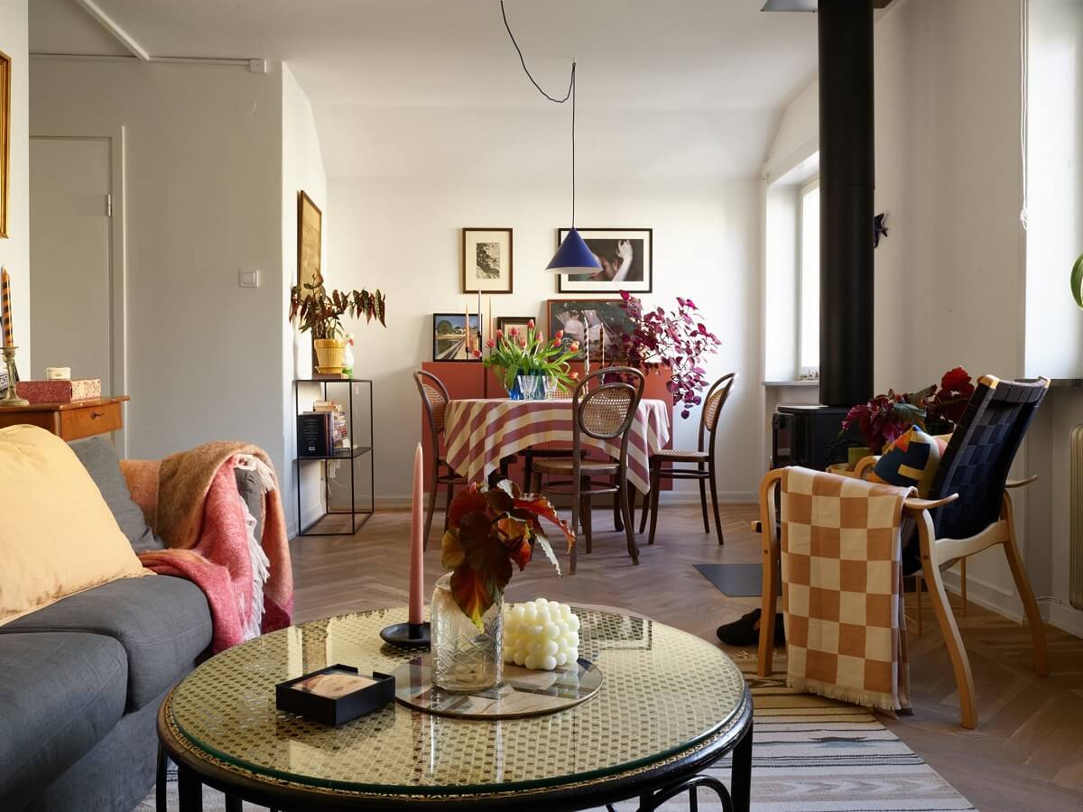 A Small Attic Apartment with a Golden Yellow Bedroom 6 living room with wooden beam and round dining table