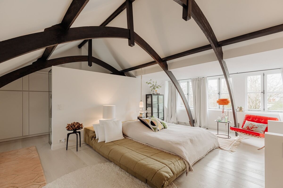 A Beautifully Renovated Dike House in The Netherlands 19 loft bedroom with exposed beams