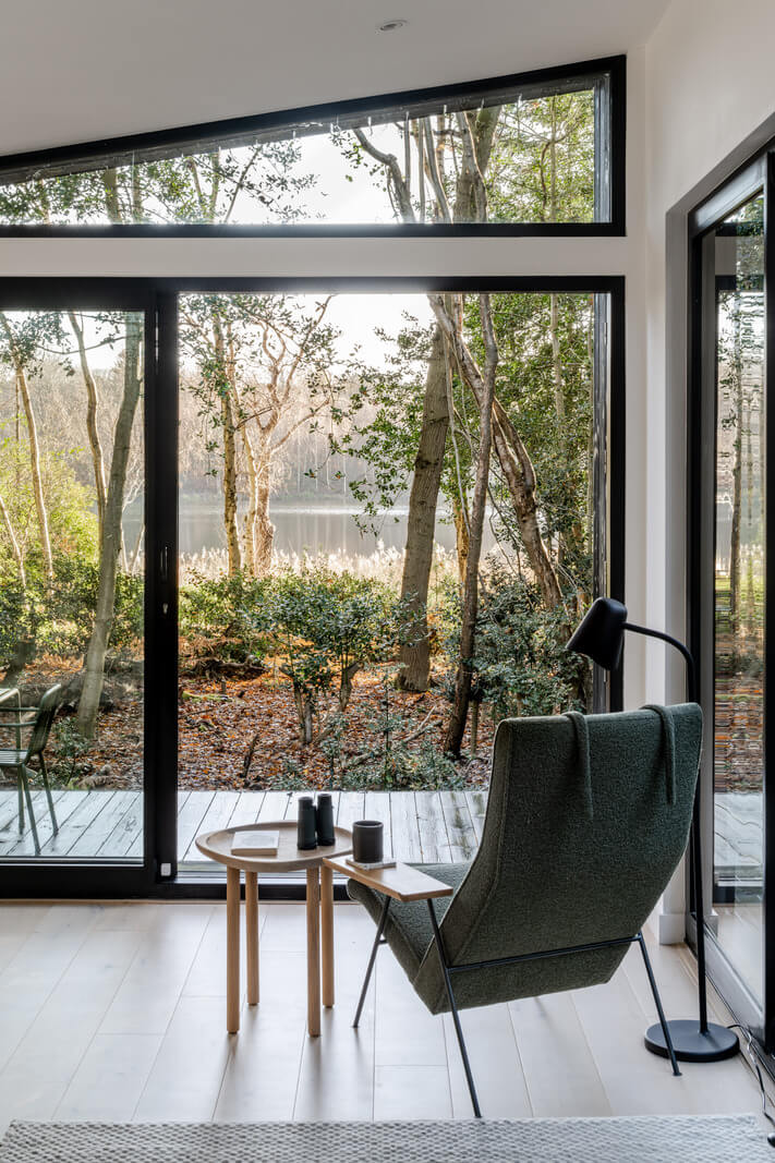 A Scandinavian-Inspired Cabin in the Woods 4 lounge chair in front of window cabin