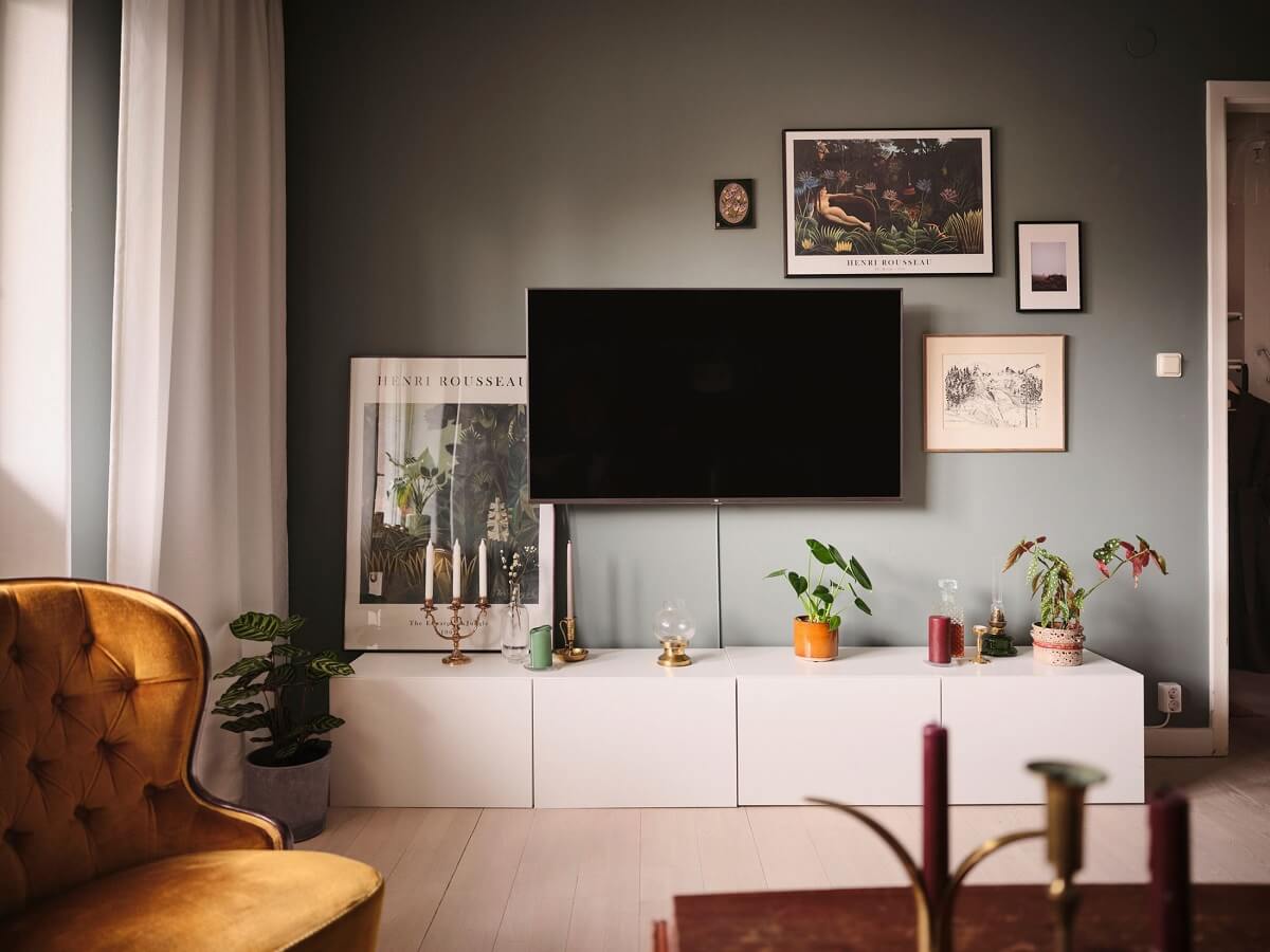 A Small Midcentury Apartment in Stockholm 4 low white cabinets and gray walls