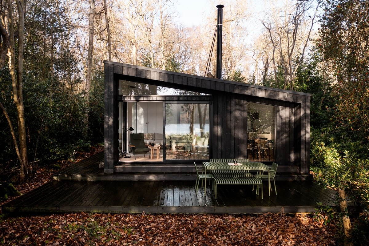 A Scandinavian-Inspired Cabin in the Woods 19 modern black cabin in the woods with terrace