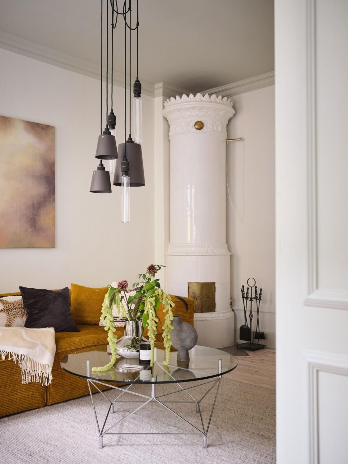 A Light Filled Duplex Apartment in Sweden 12 mustard yellow sofa and round fireplace