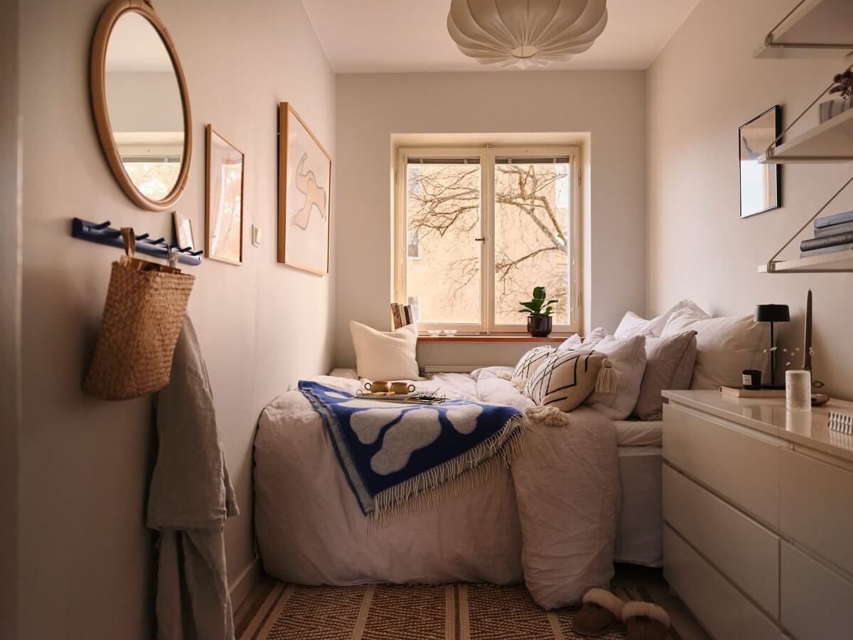 A Small Midcentury Apartment in Stockholm 9 narrow bedroom with malm dressers