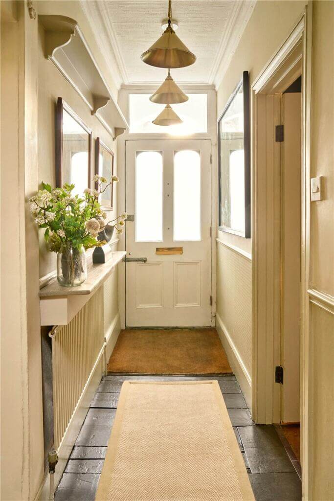 A Warm Muted Color Palette in a Victorian House 27 narrow hallway with wooden floor