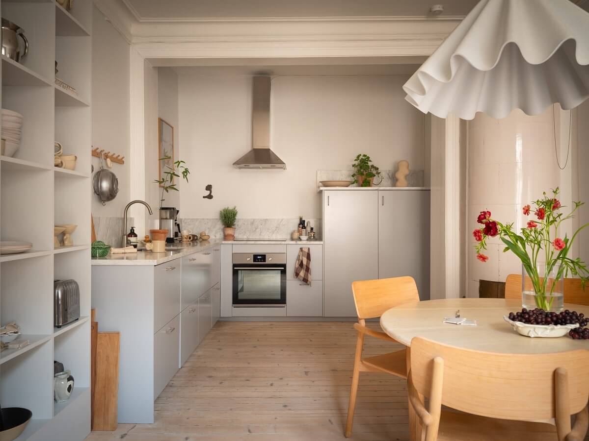 Light Rooms and Soft Color Tones in a Swedish Apartment 9 open kitchen with light gray cabinets and round dining table