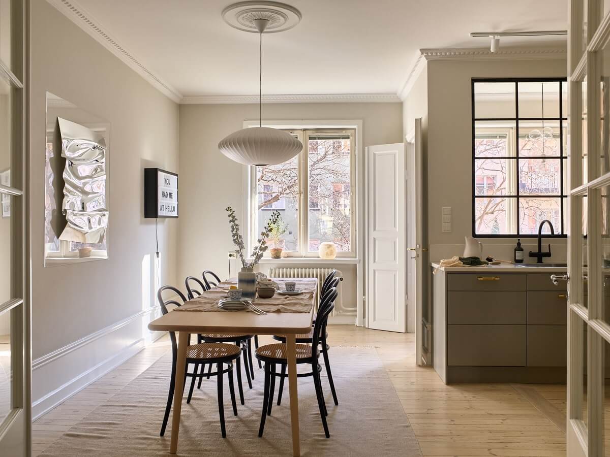A Social Scandinavian Apartment with a Light Blue Living Room 8 open plan kitchen and dining room with light gray walls