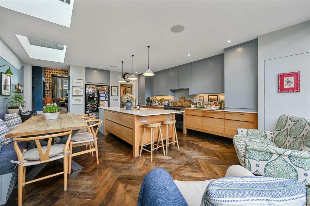 A London Family Home with Blue Color Accents 7 open plan kitchen dining room with wooden floor