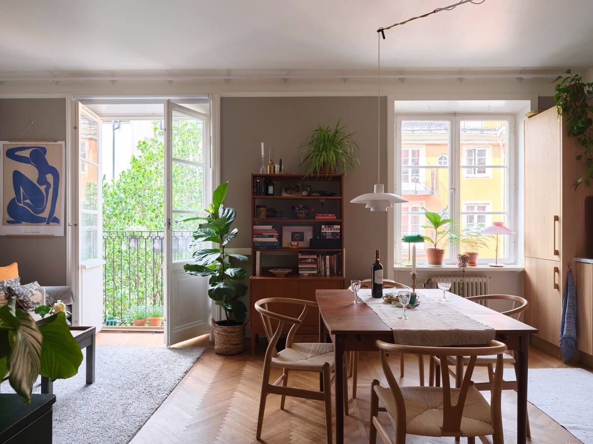 A Small Gray Apartment with Industrial Glass Walls 1 open plan living room and kitchen with gray walls