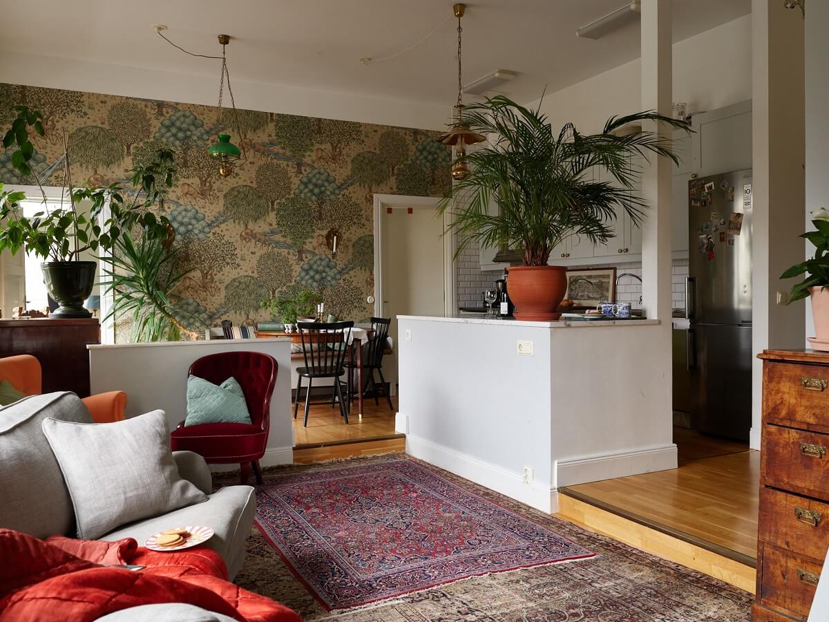 Floor-to-Ceiling Bookcases in a 1950s Swedish Home 6 open plan living room and kitchen with william morris wallpaper