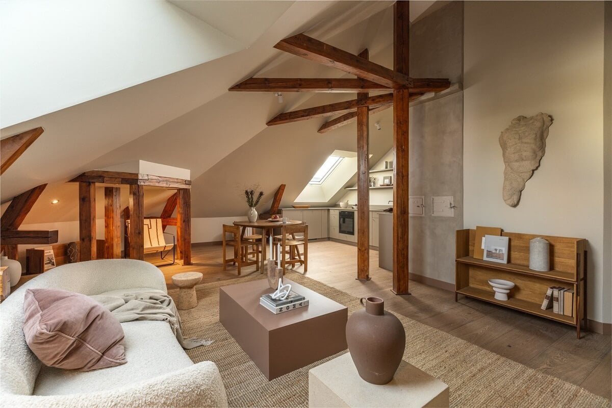 An Attic Apartment in Oslo with Exposed Wooden Beams 2 open plan living room with slanted ceiling and exposed beams
