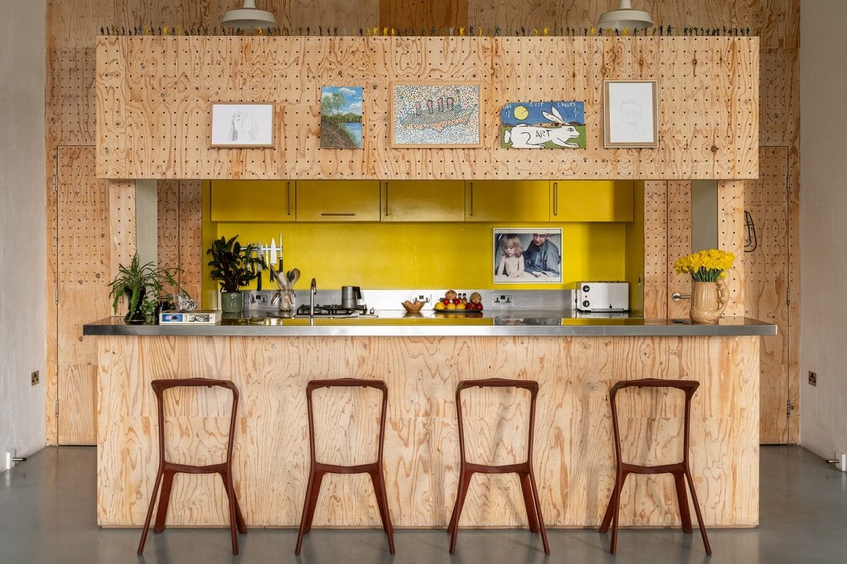 An Industrial English Loft with Yellow Color Pops 9 plywood kitchen with bar and yellow cabinets
