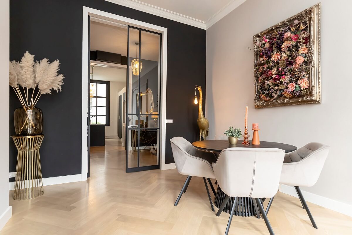 A Renovated Canal House with a Separate Pink Studio Apartment 5 round dining table and dark gray accent wall