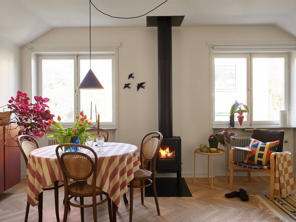 A Small Attic Apartment with a Golden Yellow Bedroom 7 round dining table with striped tablecloth