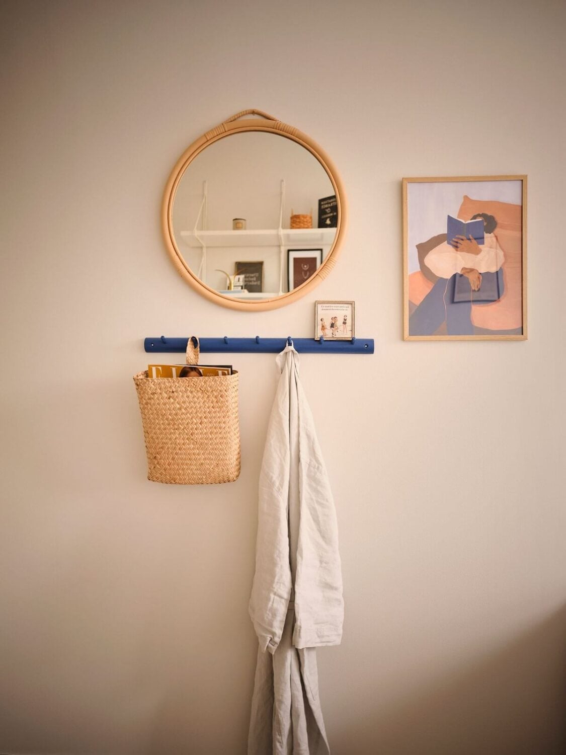 A Small Midcentury Apartment in Stockholm 12 round mirror and blue hooks in bedroom