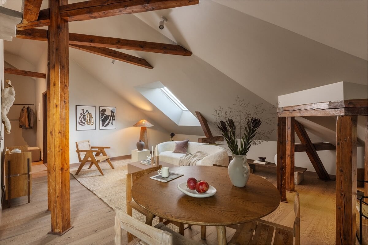 An Attic Apartment in Oslo with Exposed Wooden Beams 6 round wooden dining table
