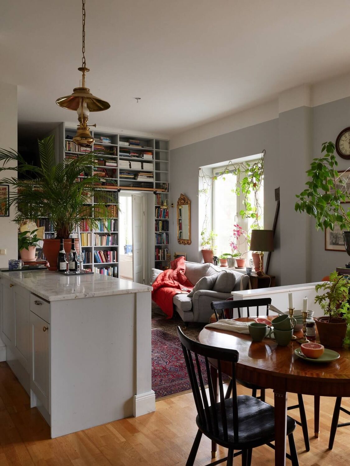 Floor-to-Ceiling Bookcases in a 1950s Swedish Home 7 round wooden dining table in open plan living space