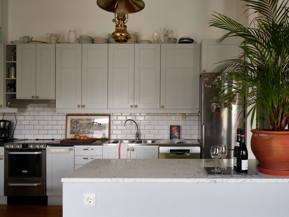 Floor-to-Ceiling Bookcases in a 1950s Swedish Home 12 scandi kitchen with white tiles