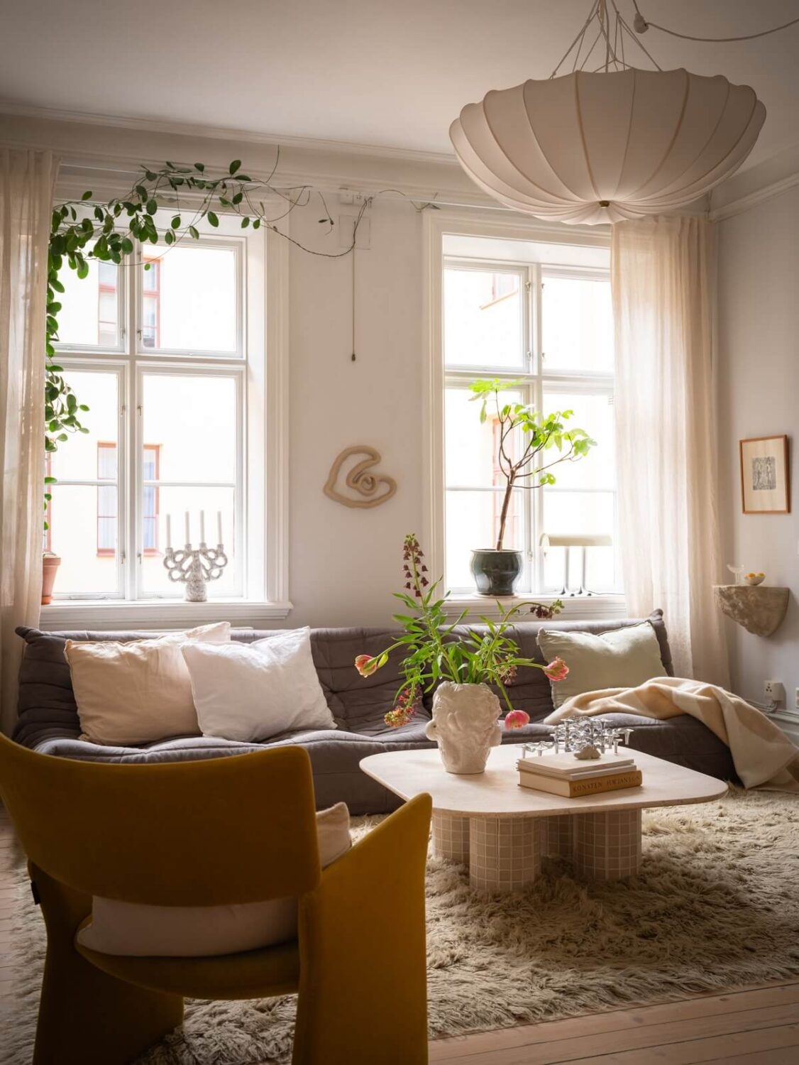Light Rooms and Soft Color Tones in a Swedish Apartment 2 scandinavian living room with large rug and ligne roset sofa nordroom