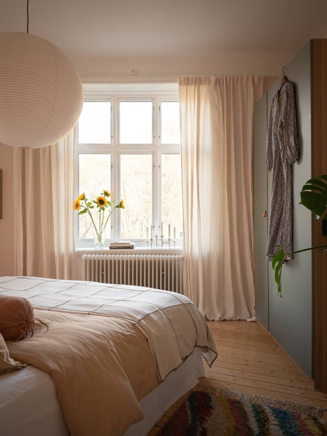 A Scandinavian Apartment with a Warm Living Room and Rounded Walls 15 serene bedroom with blue wardrobes