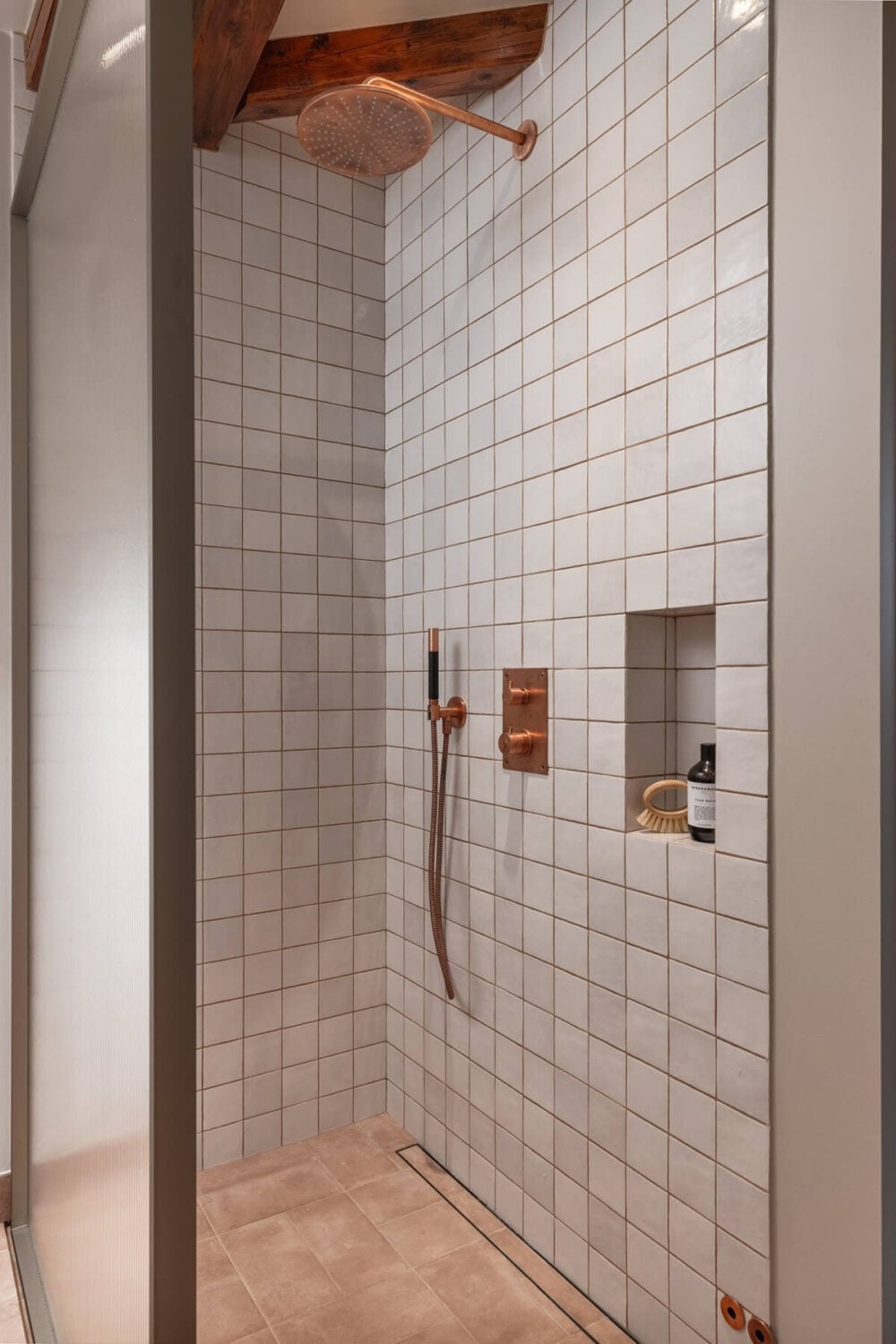 An Attic Apartment in Oslo with Exposed Wooden Beams 13 shower with storage niche