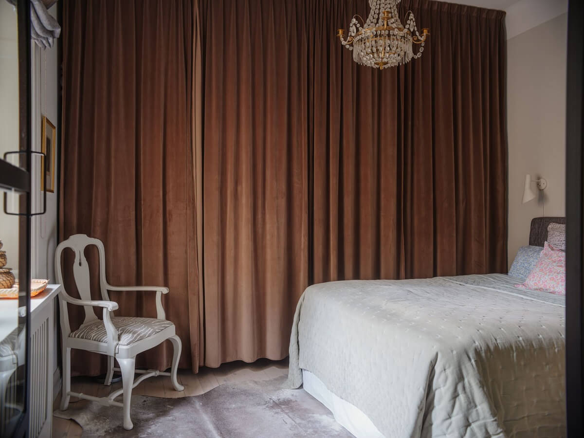 A Muted Color Palette in a Scandinavian Apartment 11 small bedroom with brown curtain