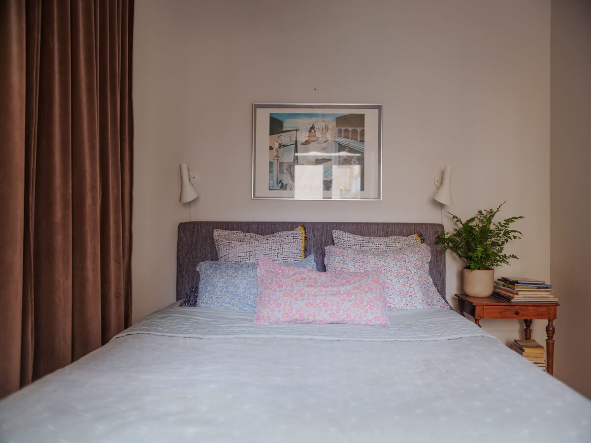 A Muted Color Palette in a Scandinavian Apartment 13 small bedroom with wardrobe behind curtain