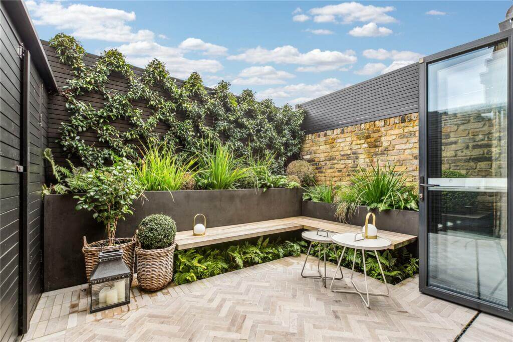 An Extended Victorian House Decorated in Gray Tones 6 small garden with built in bench