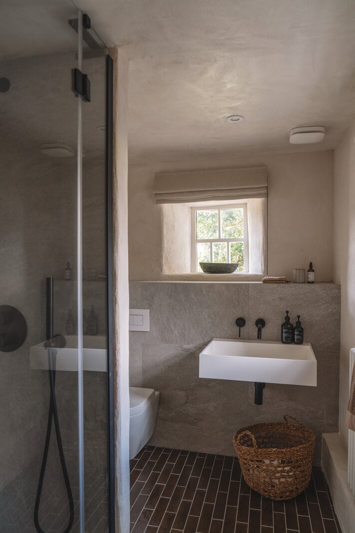 Contemporary Interiors in a Historic English House 19 small gray bedroom with tile floor