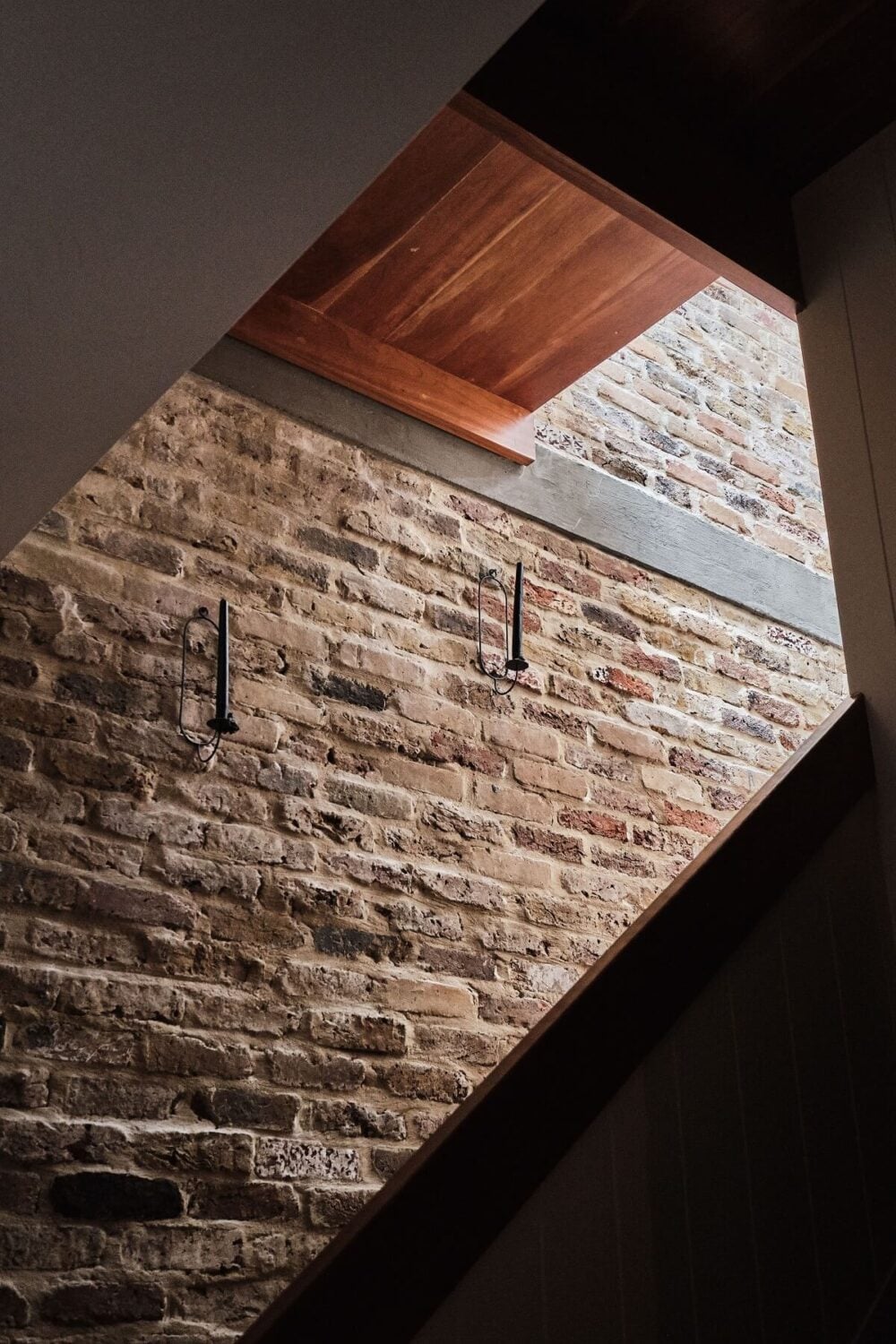 A London Warehouse Conversion with a Black deVOL Kitchen 8 staircase with brick wall