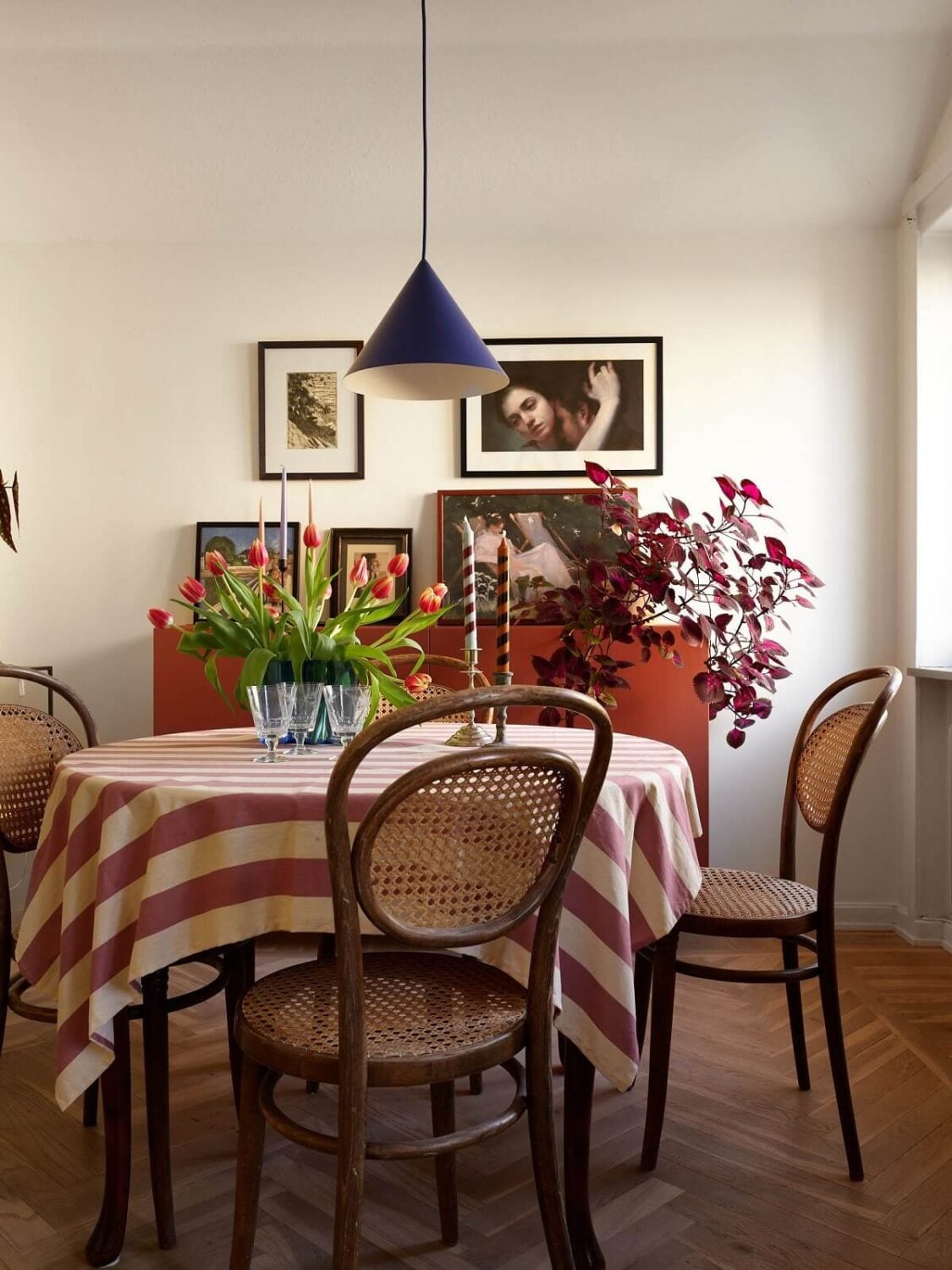 A Small Attic Apartment with a Golden Yellow Bedroom 8 striped tablecloth and red cabinet