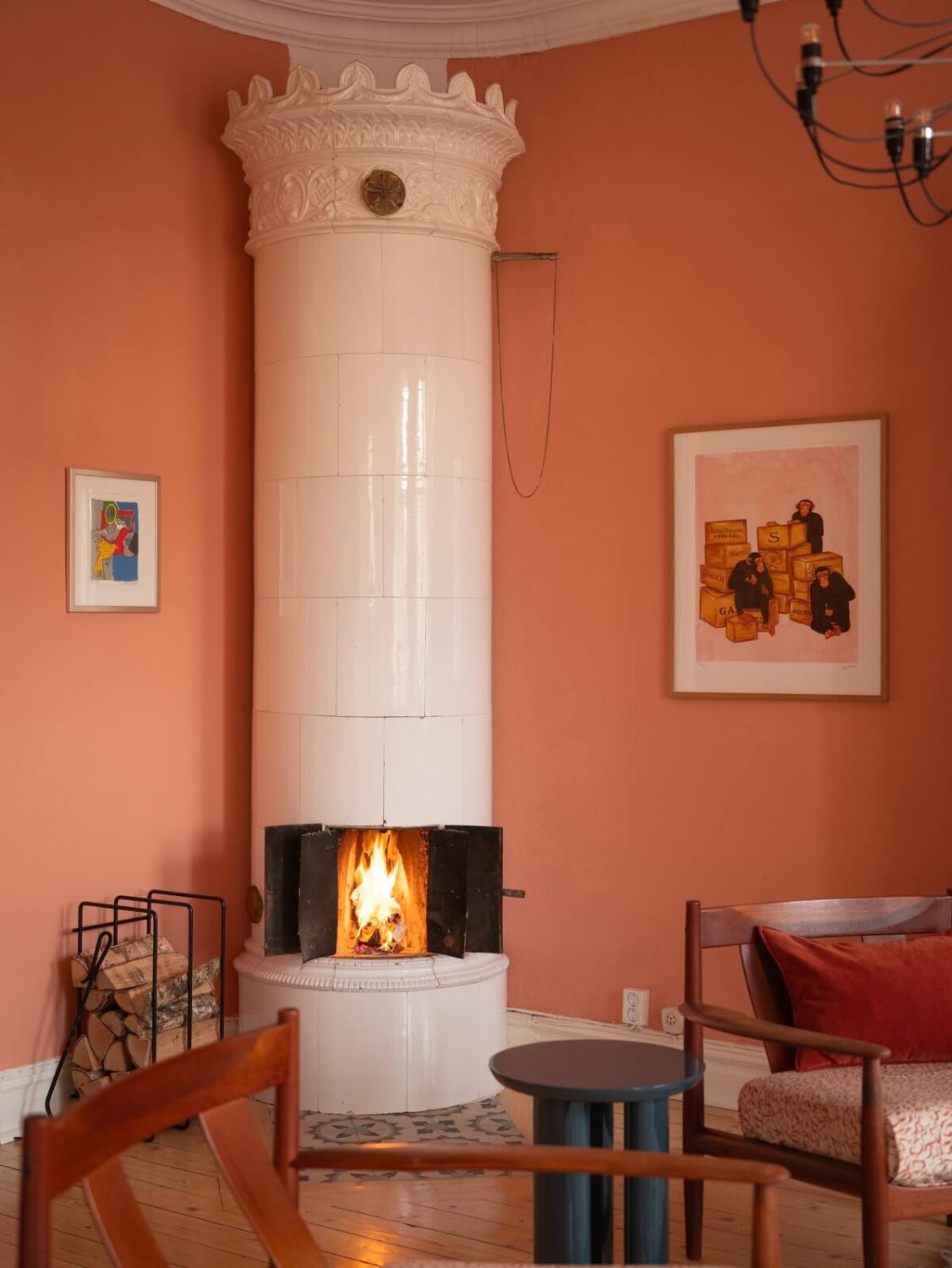 A Scandinavian Apartment with a Warm Living Room and Rounded Walls 7 swedish tile fireplace