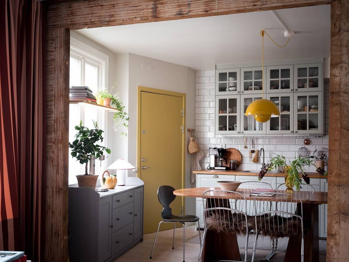 A Beautiful Color Palette in a Scandinavian Family Apartment 10 view into kitchen with wooden beams
