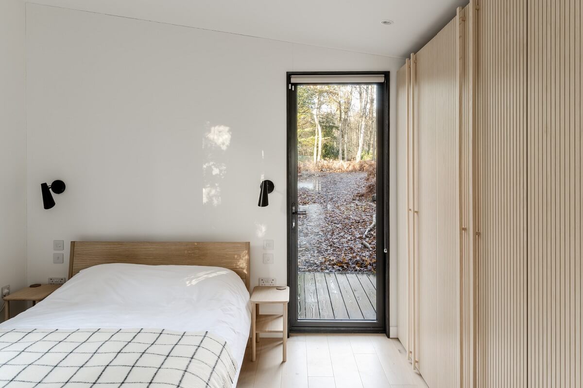 A Scandinavian-Inspired Cabin in the Woods 11 white bedroom built in wardrobes