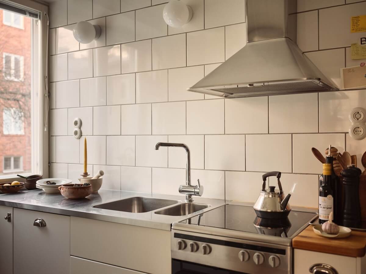 A Small Apartment with a Cozy Dining Nook 8 white kitchen