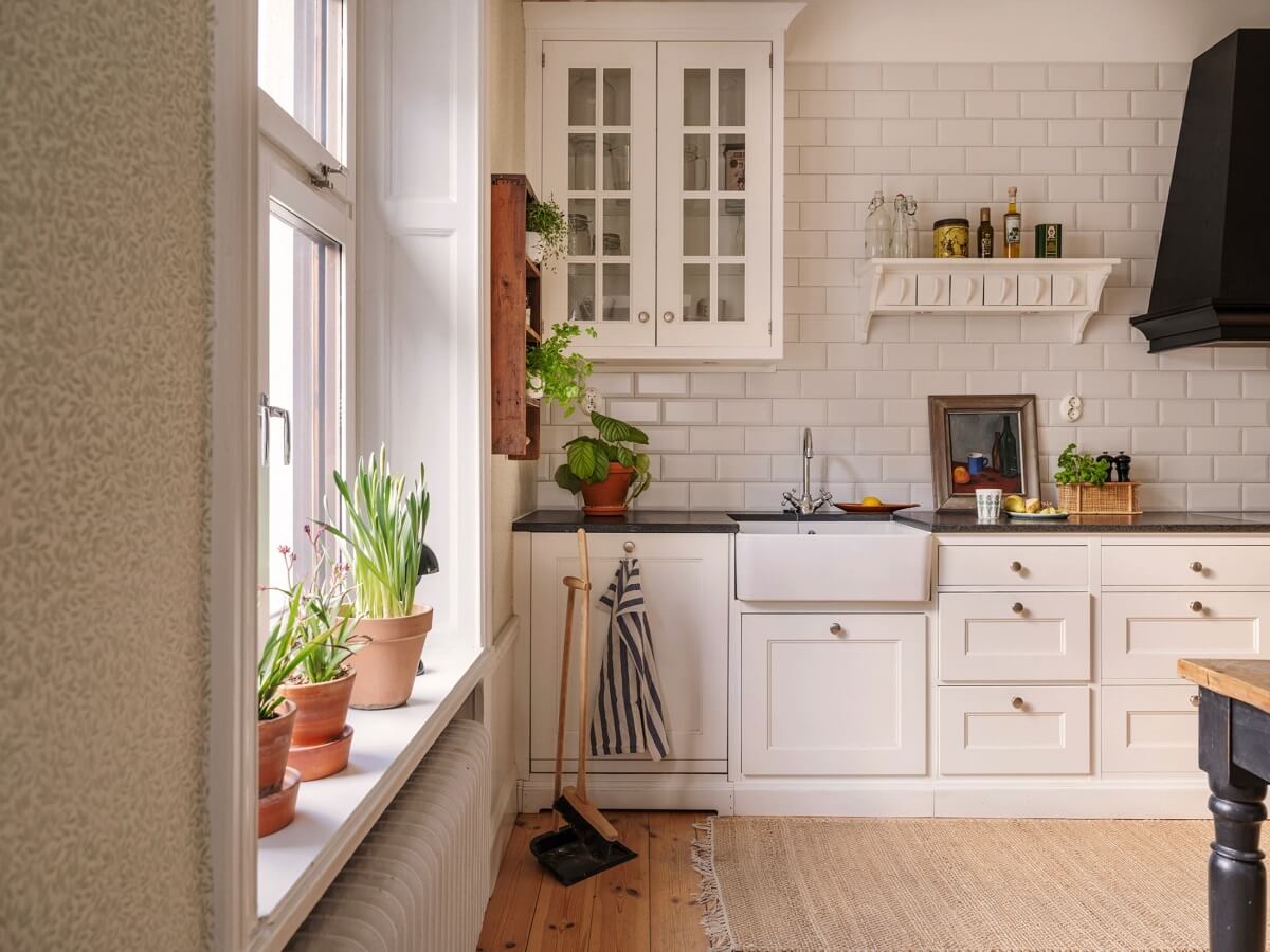 A Classic Swedish Apartment Decorated in Green and Pink Tones 15 white kitchen with butler sink