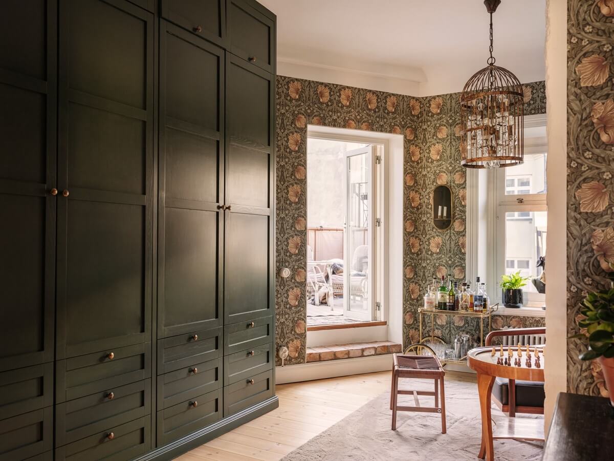 A Classic Swedish Apartment Decorated in Green and Pink Tones 12 william morris wallpaper and floor to ceiling wardrobes